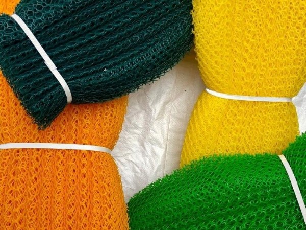 4 colorful plastic sericulture net rolls are displayed on a white background.