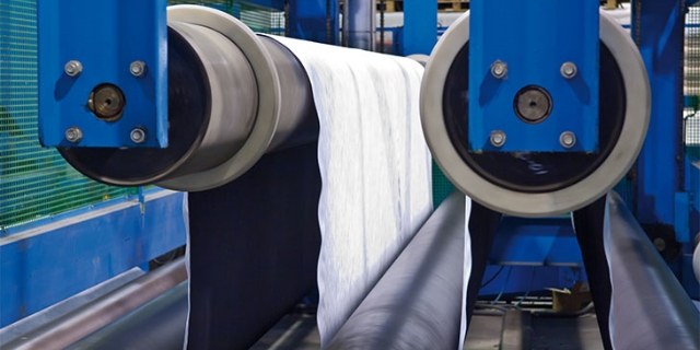 The machine bonds the plastic net with other geotechnical products.