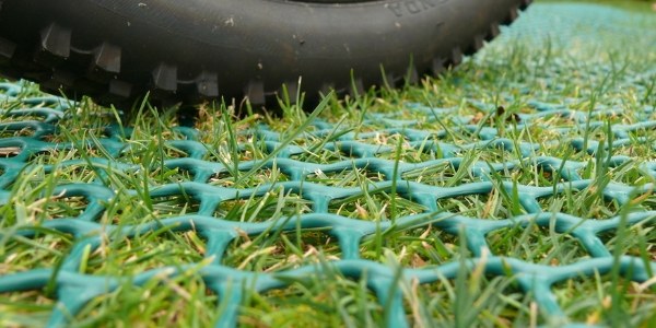The vehicle is driving on the lawn reinforcement net.
