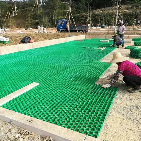 Many workers are installing the plastic grass paver on the park.