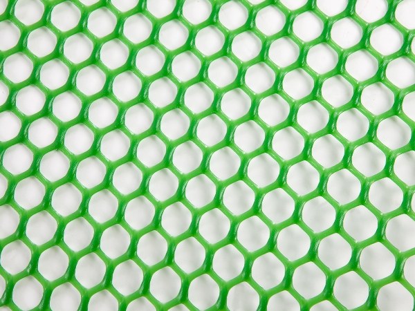 Green plastic mattress netting on a white background