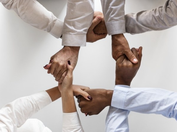 Many hands are holding together.