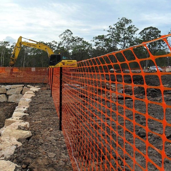 Safety barrier fence is installed along the construction site.