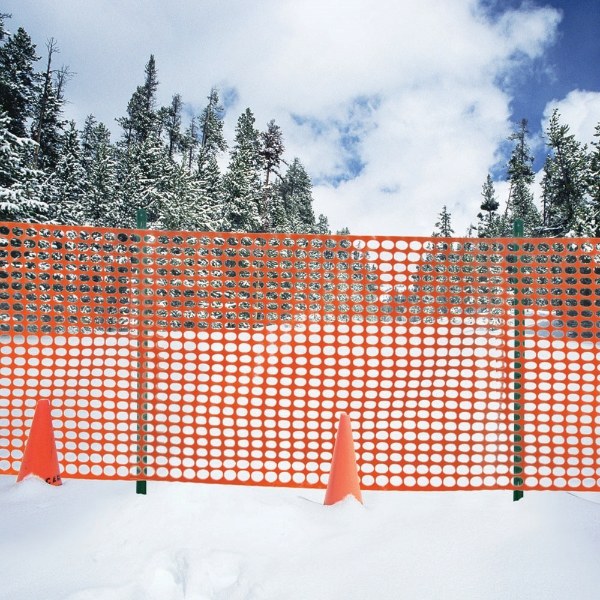 Safety barrier fence is installed on snow field.