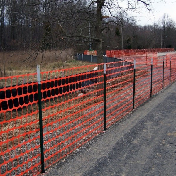 Safety barrier mesh is installed along the road.