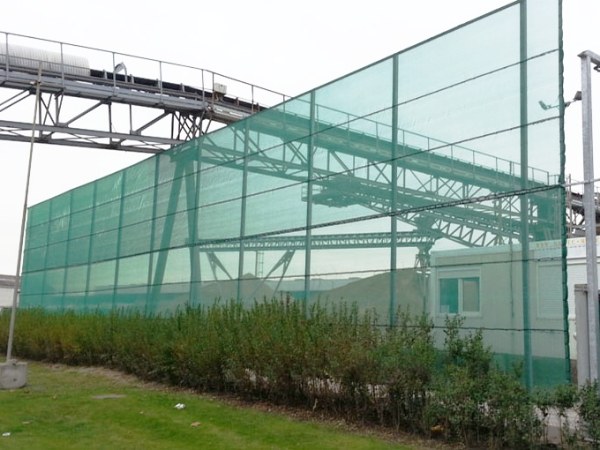 Windbreak net is installed on a metal bracket in front of the house.