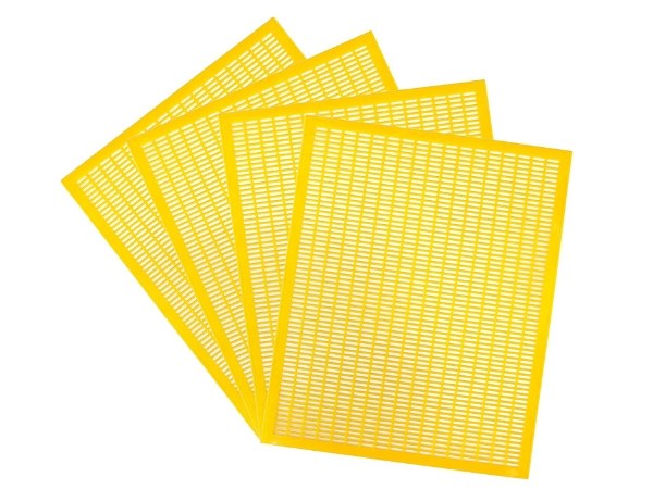 Yellow plastic queen excluder on a white background